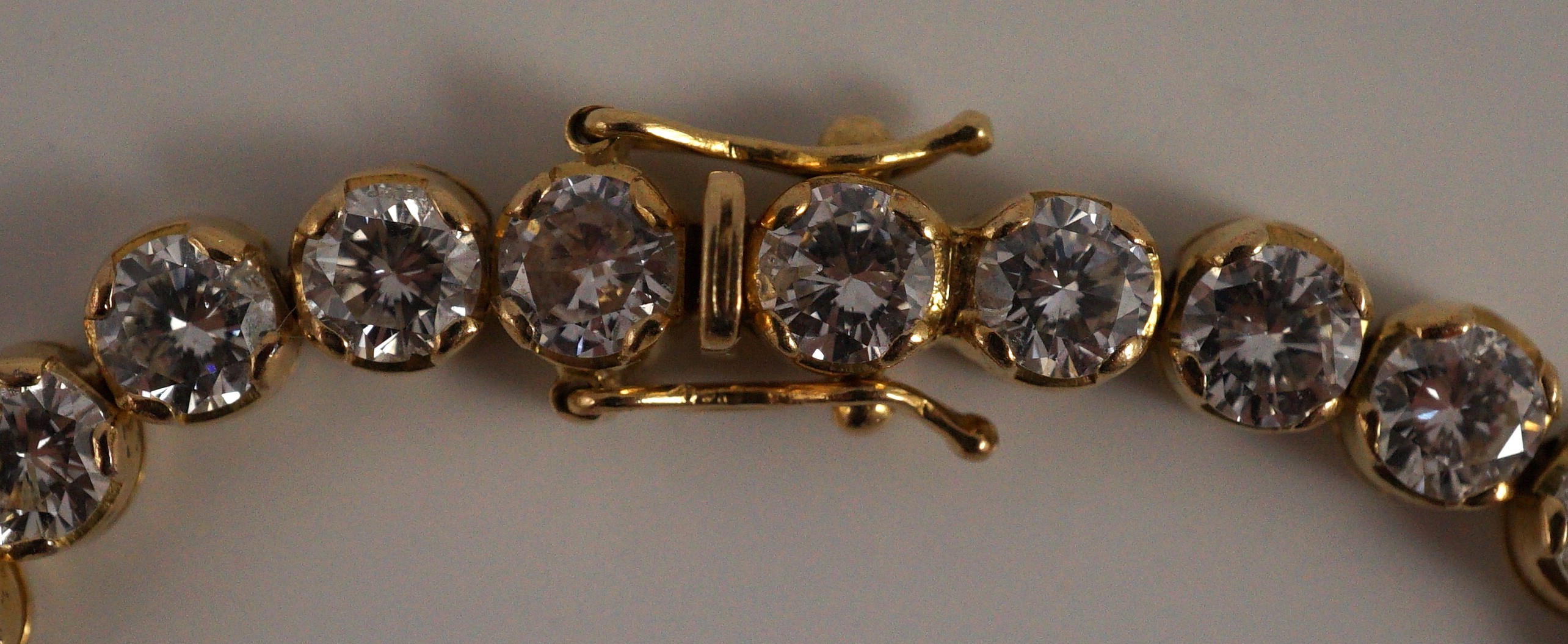 A modern 18k gold and round brilliant cut diamond set line bracelet